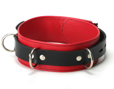 This stylish red and black leather collar is made with function, appearance, design and the end user in mind. Unlike some collars, the leather completely covers the collar, giving you full comfort and durability. It has three individual D-rings for attachment to leashes or other gear. The collar features a lockable buckle so can also use a padlock to make sure that it does not come off until you're ready.

The collar can fit necks between 14" to 20.5". The collar itself is red leather with black outlined stitching. The band that holds the collar around the neck is made of high quality black leather. The collar is 2" wide.
